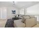 Bright living room with vaulted ceilings, large sectional, and decorative rug at 8714 Las Posas Ave, Las Vegas, NV 89147