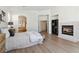 This main bedroom features a fireplace, wood floors and great light at 8714 Las Posas Ave, Las Vegas, NV 89147