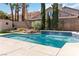 Sparkling pool with manicured landscaping creates a serene backyard oasis at 8714 Las Posas Ave, Las Vegas, NV 89147