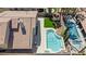 Aerial view of a backyard featuring a blue swimming pool, small grass yard, and shed at 8714 Las Posas Ave, Las Vegas, NV 89147
