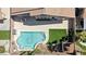 Aerial view of a backyard featuring a blue swimming pool, small grass yard, and lounge chairs at 8714 Las Posas Ave, Las Vegas, NV 89147