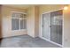 A cozy, neutral-toned balcony featuring a sliding glass door and a large window for ample natural light at 8725 Red Rio Dr # 203, Las Vegas, NV 89128