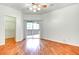 Spacious bedroom with hardwood floors, ceiling fan, walk-in closet, and sliding glass door at 8725 Red Rio Dr # 203, Las Vegas, NV 89128