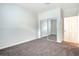 Bright bedroom featuring neutral carpet and a mirrored sliding-door closet at 8725 Red Rio Dr # 203, Las Vegas, NV 89128
