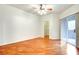 Spacious bedroom with hardwood floors, ceiling fan, walk-in closet, and sliding glass door at 8725 Red Rio Dr # 203, Las Vegas, NV 89128