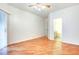 Spacious bedroom with hardwood floors, ceiling fan, walk-in closet, and sliding glass door at 8725 Red Rio Dr # 203, Las Vegas, NV 89128