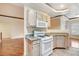 Open kitchen design with granite counters, white appliances, and seamless access to the living area at 8725 Red Rio Dr # 203, Las Vegas, NV 89128