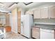 Bright kitchen features wooden cabinetry, granite countertops, and modern white appliances at 8725 Red Rio Dr # 203, Las Vegas, NV 89128