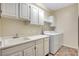 Well-lit laundry room with a sink, washer, and dryer at 8725 Red Rio Dr # 203, Las Vegas, NV 89128