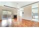 Bright living area featuring hardwood floors, fireplace, slider doors to balcony, and an adjacent kitchen at 8725 Red Rio Dr # 203, Las Vegas, NV 89128