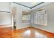 Sunlit living area boasts hardwood floors, large window, and fireplace at 8725 Red Rio Dr # 203, Las Vegas, NV 89128