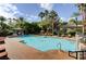 Expansive community pool with clear blue water, lounge chairs, and a gazebo amid lush greenery at 8725 Red Rio Dr # 203, Las Vegas, NV 89128