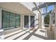 Cozy covered balcony with a neutral color palette, a tiled floor, and bright string lights at 8932 Antioch Way, Las Vegas, NV 89117