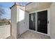 Balcony area with a white storage closet and sliding glass doors leading indoors at 8932 Antioch Way, Las Vegas, NV 89117