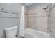 Bathroom with a tiled shower and tub featuring a shower curtain, and a white toilet at 8932 Antioch Way, Las Vegas, NV 89117