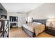 Spacious bedroom with wood floors, closet and a large bed with a wooden headboard at 8932 Antioch Way, Las Vegas, NV 89117
