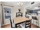 Eat-in dining area with modern light fixture, wood floors and view from the large window at 8932 Antioch Way, Las Vegas, NV 89117