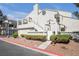Charming stucco condo with a private balcony, red rock landscaping, and well-maintained front yard at 8932 Antioch Way, Las Vegas, NV 89117