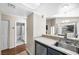 Galley kitchen with stainless steel appliances and view of the full bathroom at 8932 Antioch Way, Las Vegas, NV 89117
