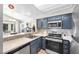 This updated kitchen features stainless steel appliances and tile backsplash at 8932 Antioch Way, Las Vegas, NV 89117