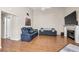 Bright living room with wood floors, vaulted ceiling, fireplace, and comfy seating at 8932 Antioch Way, Las Vegas, NV 89117