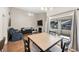 Living and dining area with hardwood floors, fireplace, and balcony with view of the community at 8932 Antioch Way, Las Vegas, NV 89117