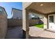 This backyard patio has brick pavers, small patch of green grass, and a covered area perfect for outdoor entertaining at 9239 Albus Hills Ave, Las Vegas, NV 89143