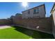 Fully fenced backyard with well maintained block wall and a small patch of green grass at 9239 Albus Hills Ave, Las Vegas, NV 89143