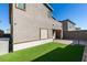 Well maintained artificial grass in backyard, block wall fence and covered patio at 9239 Albus Hills Ave, Las Vegas, NV 89143