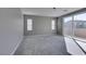 Neutral bedroom with carpet, two windows, sliding glass door, and lots of natural light at 9239 Albus Hills Ave, Las Vegas, NV 89143