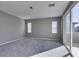 Bright bedroom with carpet, two windows, sliding glass door, and lots of natural light at 9239 Albus Hills Ave, Las Vegas, NV 89143