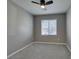Bright, carpeted bedroom with a ceiling fan and natural light from a window at 9239 Albus Hills Ave, Las Vegas, NV 89143