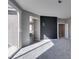 Neutral bedroom with carpet, sliding glass door to balcony, and view to hall and ensuite bathroom at 9239 Albus Hills Ave, Las Vegas, NV 89143