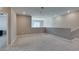 Open bonus room with neutral walls, carpet, and stairway access at 9239 Albus Hills Ave, Las Vegas, NV 89143