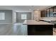 Spacious kitchen island boasts white countertops, dark cabinets, stainless steel appliances and lots of natural light at 9239 Albus Hills Ave, Las Vegas, NV 89143