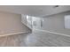 Bright, open-concept living room featuring wood-style tile flooring and a staircase at 9239 Albus Hills Ave, Las Vegas, NV 89143