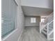 Bright living room with modern gray walls, wood-look tile flooring, and plenty of natural light at 9239 Albus Hills Ave, Las Vegas, NV 89143