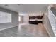 Open-concept living space featuring wood-look tile floors and gray walls that leads into the kitchen at 9239 Albus Hills Ave, Las Vegas, NV 89143
