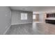 Spacious living room with gray walls, tile floors, and an open floor plan to the kitchen at 9239 Albus Hills Ave, Las Vegas, NV 89143
