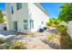 Rear yard with low maintenance landscaping, a patio, and AC units along the exterior wall at 9408 Amber Valley Ln, Las Vegas, NV 89134