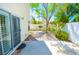 Enclosed backyard with a patio, mature trees, and privacy wall, perfect for outdoor relaxation at 9408 Amber Valley Ln, Las Vegas, NV 89134