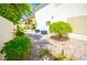 Backyard features a low maintenance gravel yard with a tree and AC units at 9408 Amber Valley Ln, Las Vegas, NV 89134