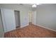 Bright bedroom featuring wood floors, neutral walls, closet with sliding doors, and a ceiling fan at 9408 Amber Valley Ln, Las Vegas, NV 89134