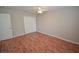 Bedroom featuring hardwood floors, neutral walls, and a closet with sliding doors at 9408 Amber Valley Ln, Las Vegas, NV 89134