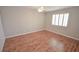 Bedroom boasts hardwood flooring, neutral walls, and plantation shutters for abundant natural light at 9408 Amber Valley Ln, Las Vegas, NV 89134