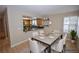 Dining area with a passthrough view of the kitchen, neutral colors, and natural light at 9408 Amber Valley Ln, Las Vegas, NV 89134