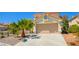 Charming two-story home featuring a tile roof and well-maintained landscaping with desert accents at 9408 Amber Valley Ln, Las Vegas, NV 89134