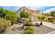 Charming two-story home with a tile roof, attached garage, and xeriscaped front yard at 9408 Amber Valley Ln, Las Vegas, NV 89134