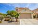 Beautiful single-Gathering home featuring desert landscaping, a two-car garage and a traditional roof at 9408 Amber Valley Ln, Las Vegas, NV 89134