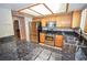 Modern kitchen featuring stainless steel appliances, granite countertops, and wood cabinets at 9408 Amber Valley Ln, Las Vegas, NV 89134